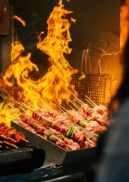 A whole goat grilling over glowing charcoal flames