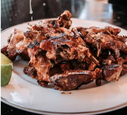 A plate of grilled goat choma ready to serve