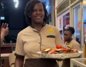 YPA Mbuzi Choma's smart waitress assisting guests at the table