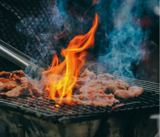 Smoke rising from the charcoal grills at YPA Mbuzi Choma